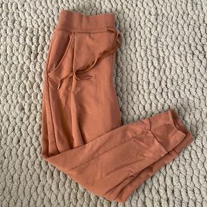 orange/tan jogger style sweatpants. size M. brand Calia by Carrie Underwood.